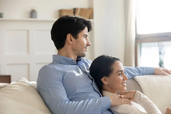 Pleasant couple in love relaxing on couch in living room — Stock Photo, Image