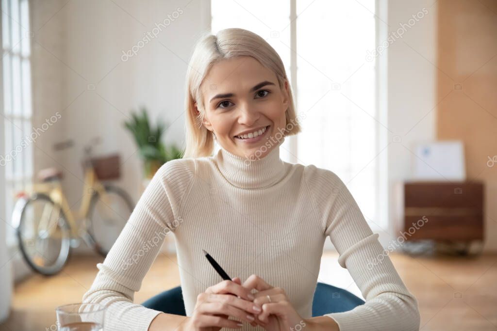 Portrait of smiling Caucasian young woman worker in office