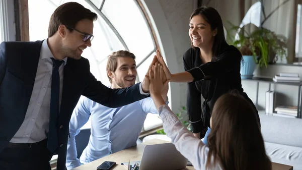 Happy motivated multiracial employees giving high five. — Stock Photo, Image