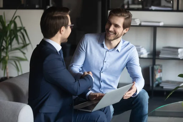 Smiling young employee shaking hands with pleasant ceo executive manager. — Stock Photo, Image