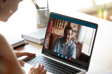 Kadın, bilgisayardaki görüntülü telefonda erkekle konuşuyor.