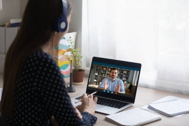 Genç bayan öğrenci öğretmenle online danışmanlık yapıyor..