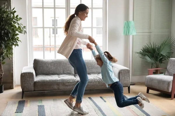 Gelukkig jong mam en kleine dochter dansen thuis — Stockfoto