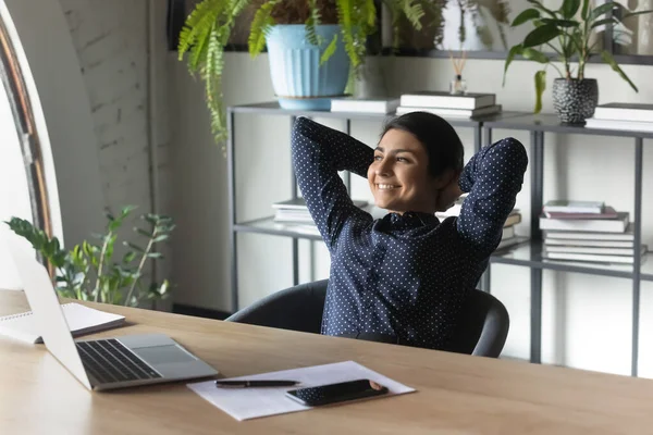 Happy indian female employee relax at workplace