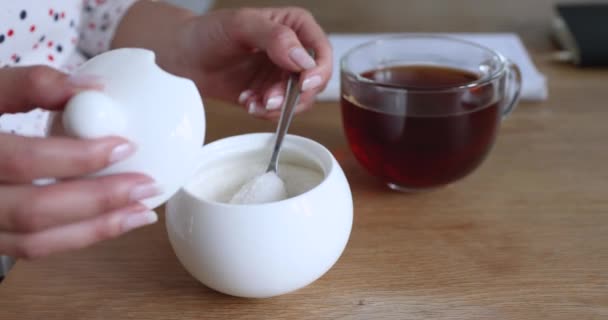 Feminino colocar açúcar na xícara com chá vista de perto — Vídeo de Stock