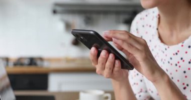 Akıllı telefon kullanan yakın çekim görüntülü kadın internette boş zaman geçiriyor