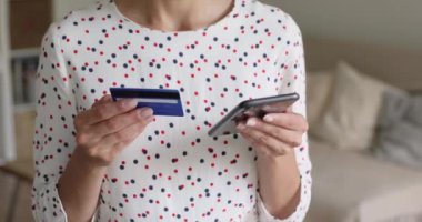Yakından bakan kadın cep telefonu ödemesini kredi kartıyla yapıyor