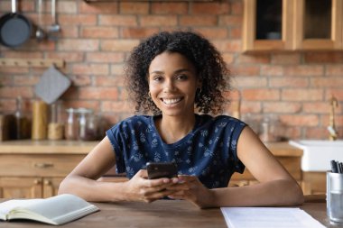 Gülümseyen melez kadının portresi ev telefonunda kullanılıyor.