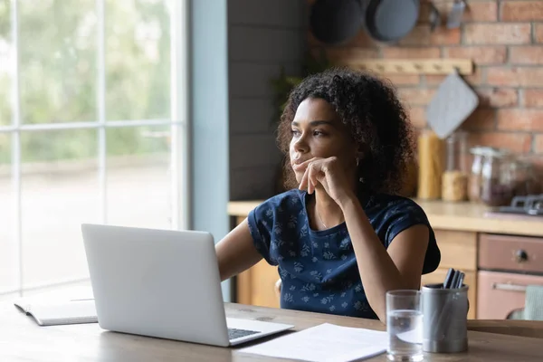 Pensive African American woman work on laptop thinking — Stock Photo, Image