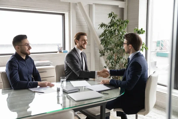 Happy diverse businessmen celebrating reaching agreement at meeting. — Stock Photo, Image