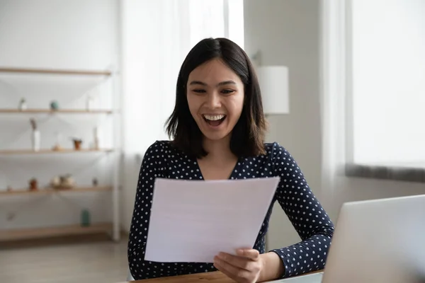 Überglückliches asiatisches Mädchen liest gute Nachrichten in Papierbrief — Stockfoto