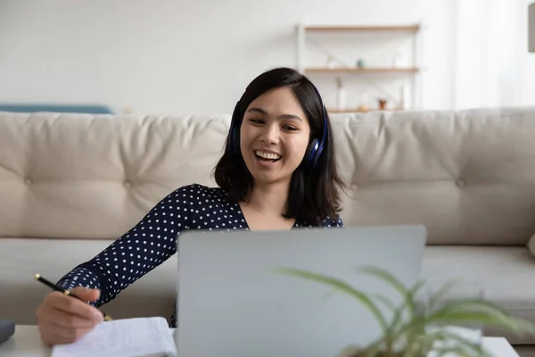 Happy Asian girl laugh watching webinar on laptop