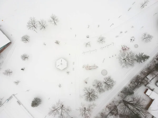 High level of snow and snow storm winter weather forecast alert day in the city. Top aerial view of the kids playground from the bird view. Children\'s park is covered in thick layer of snow. Canada.