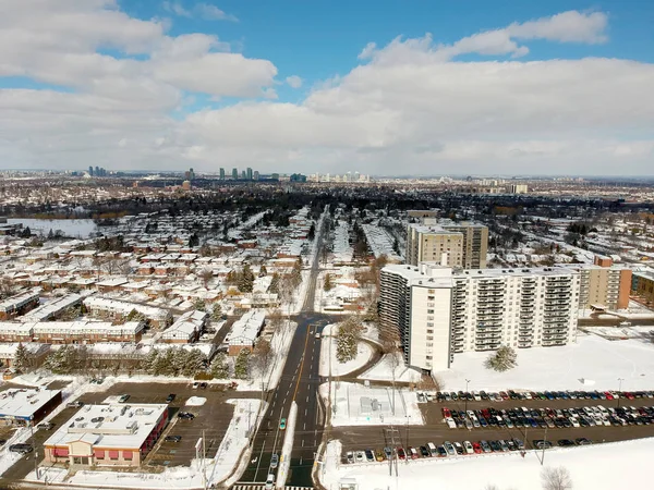 Aerial bird eye view skyline at Winter season in Canada. Hundreds of low and high rise houses from top view in the background covered in high level of snow.