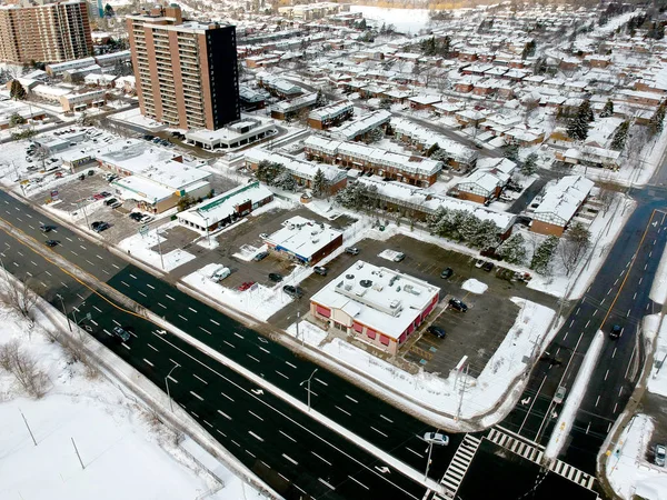 Snow view from the top with urban city, aerial photography over the suburb. Winter scenery of the American city from the bird eye.