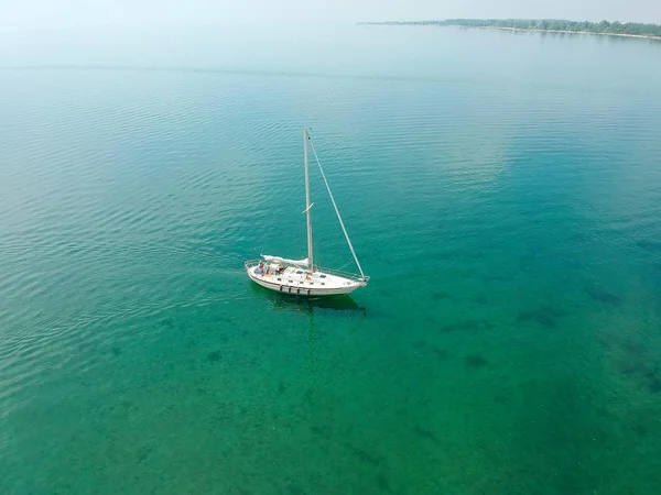 Aerial view on the sea and boat. Beautiful natural seascape at the summer time from bird eye view. Aerial.