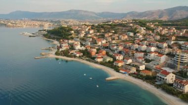 Sabah Split Hırvatistan, sakin ve oldukça turizm meslek otel sahil yeşil dağların Avrupa'nın altında yakınındaki kıyı köyü'nde doğal hava kuş görünümü. Sabah erken.