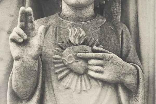 Detail of Holy Family. Young Jesus with sacred heart. Statue dep