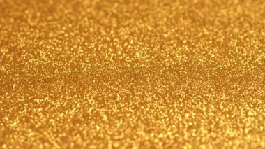 Altın parıldayan soyut sorunsuz dönen döngü hareket arka plan. Glitter parıltılar gerçek malzeme iplikten yapılmış. Yanlarda bokeh ile orta odaklanın. Uhd 4k video.