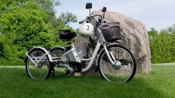 Electric trike or e bicycle in the park in sunny summer day. Sho