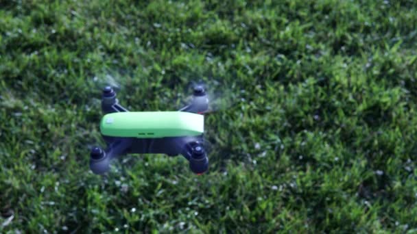 Extreme close up of the drone flying against green grass at the sunny morning, summer. 4k. — Stock Video