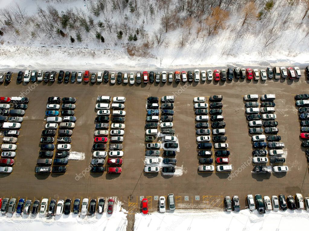 Car parking lot at winter viewed from above. Bird eye aerial vie