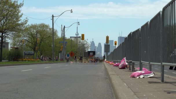 Toronto, Ontario, Canada - May 24, 2020 Crowds of cyclists, runner and walkers at city roads during COVID 19 pandemic. Physical distancing and active lifestyle practicing. Temporary installations. — Stock Video