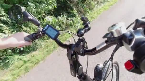 Riding on electric bike, E-bike or bicycle. Power control and switch on the arm fork view. Control board or controller to choose speed and power level. Natural lighting. — Stock Video