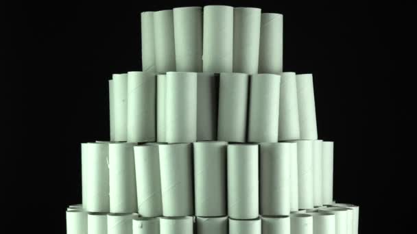 Empty toilet paper rolls on black background. Pyramid of hygiene items, empties toiletries exhausted during Covid-19 coronavirus epidemic lockdown. Empty stocks at quarantine and self-isolation. — Stock Video