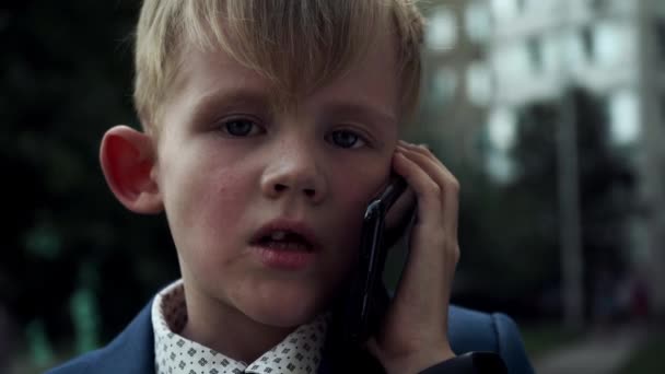 Little Boy Serious Face Business Suit Talking Phone Dolly Zoom — Stock Video