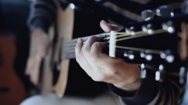 Guitarist playing acoustic guitar close up