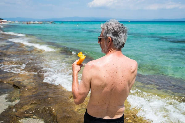 Senior Man Applying Sun Lotion Summer Vacation Back View — Stock Photo, Image