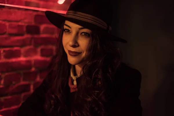 Brunette with a black hat in a bar — Stock Photo, Image
