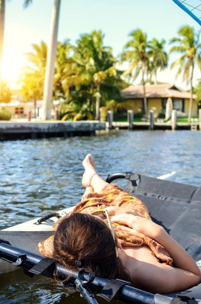 Girl lying in a sailing catamaran — Stock Photo, Image