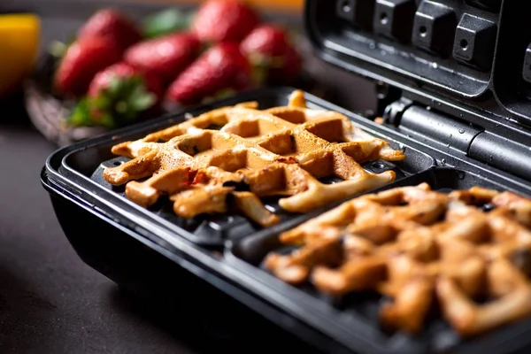 Waffle pastry baking on a waffle maker close up — Stock Photo, Image