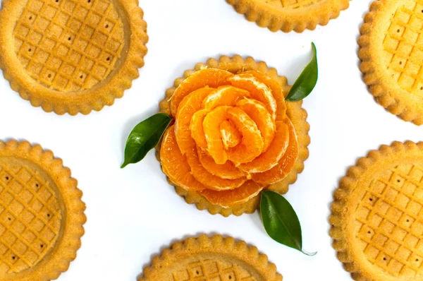 Gouden koekjes met oranje geïsoleerd op wit — Stockfoto