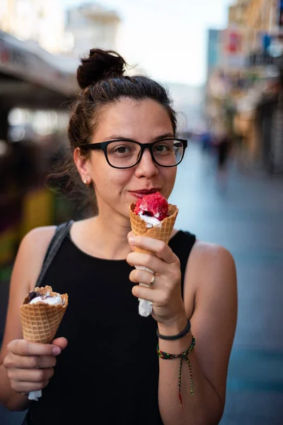 Menina comendo dois sorvetes na rua — Fotografia de Stock