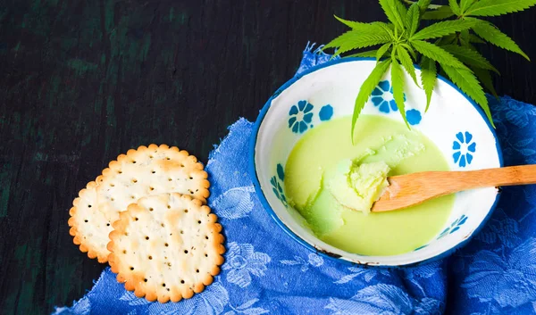 Butter with cannabis plant in a bowl — Stock Photo, Image