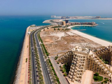 Man made Marjan Island in emirate of Ras al Khaimah in the United Arab Emirates aerial view at sunrise of the characteristic architecture and waterfront clipart