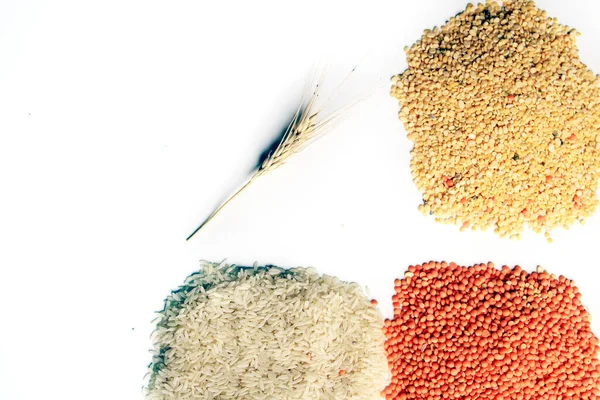 Pile of uncooked rice grain, red lentils and pigeon pea. Rice grains, Mung beans and red lentils isolated on white background. Dry food background.