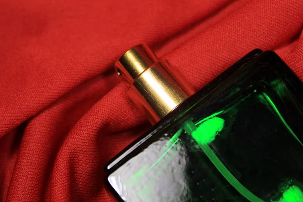 赤の背景に隔離された女性のアクセサリーと緑の色の香水瓶 — ストック写真