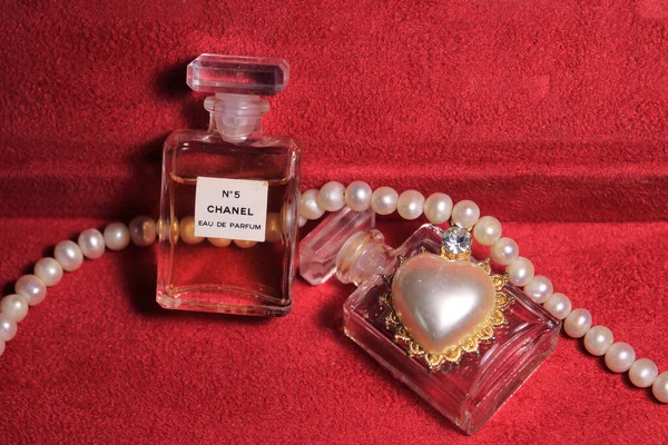 Chanel Perfume Bottles Isolated on Red Background. Bottles with