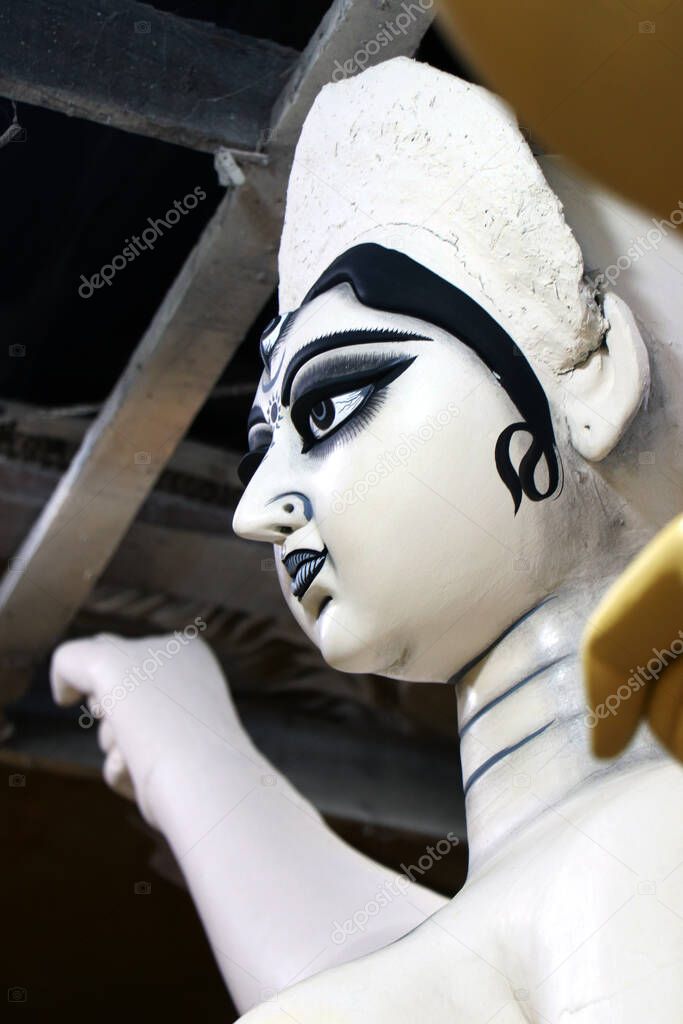 Portrait of maa Durga. Clay idol of Hindu Goddess Durga under preparations for Bengal's Durga Puja festival at Kumartuli in Kolkata.