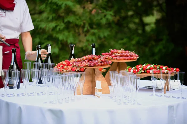 stand-up meal the Swedish table with champagne and to the appetizers and from the berries of strawberry and vine