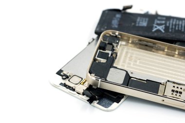 Bozuk telefon, yedek parça, şarjı bitmiş, beyaz arka planda cep telefonu var.