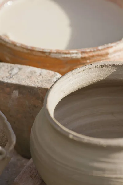 Closeup of makin vintage clay dishes outdoors