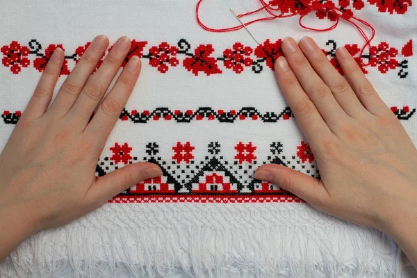 Close up of woman embroidering ethnic pattern