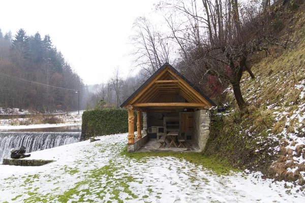 View of small waterfall and wooden patio