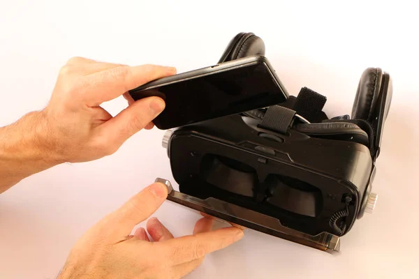 Руки вставляють смартфон для окулярів віртуальної реальності (VR ) — стокове фото