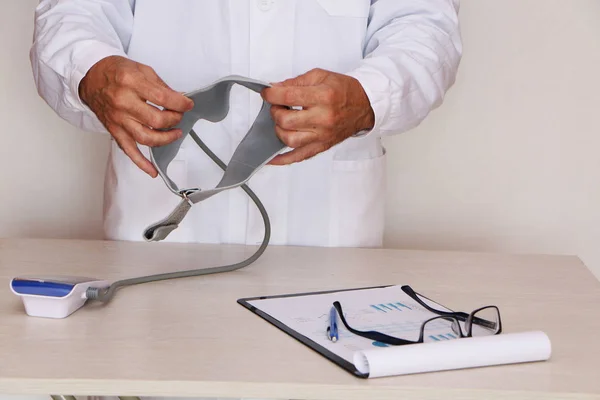 Close-up - doctor measures blood pressure